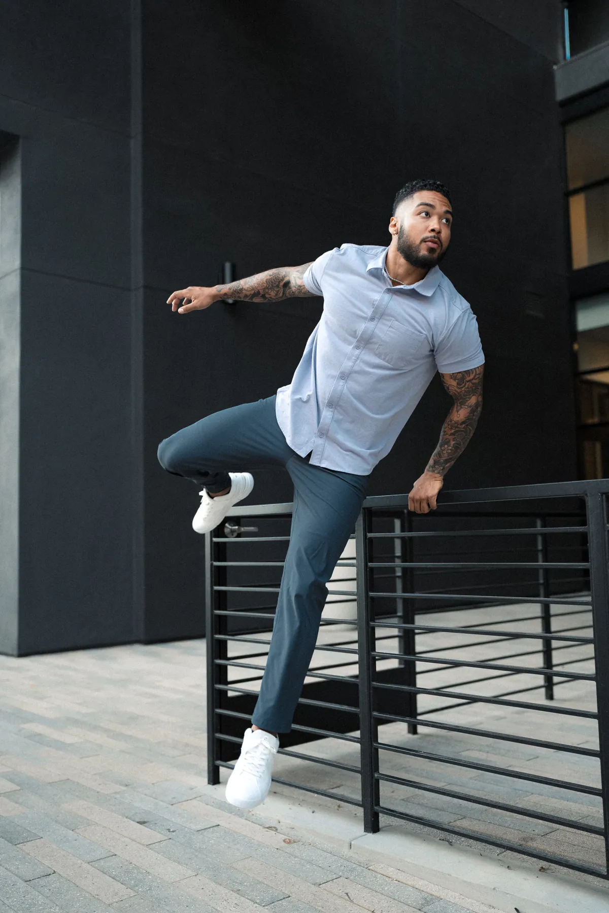 Nate Rodgers mid-movement, vaulting a railing